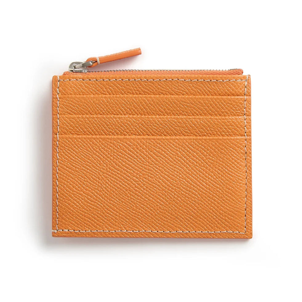 Orange leather cardholder with a zipper on a white background