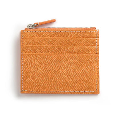 Orange leather cardholder with a zipper on a white background